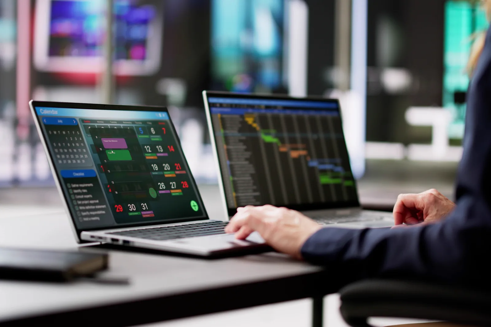 Security analytics team reviewing real-time alert and log dashboards together on a laptop in their SOC