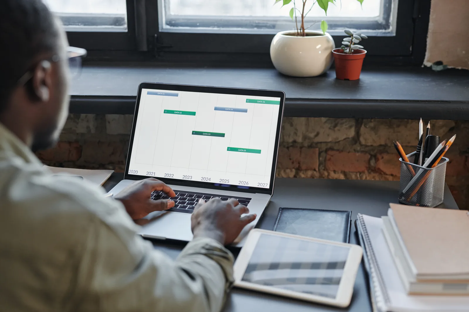 Social media manager scheduling posts across multiple platforms on a laptop content calendar