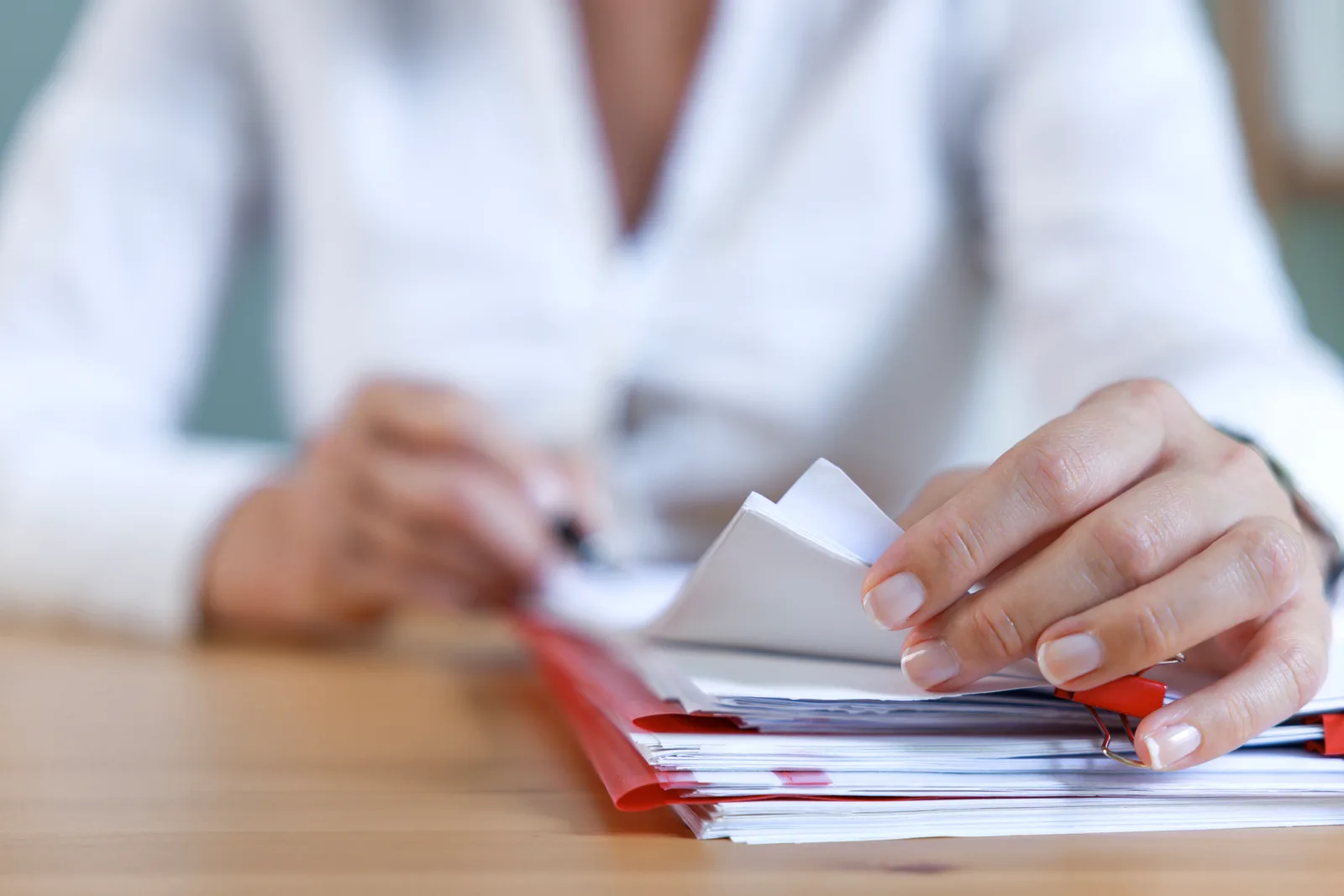 Staffing agency recruiter interviewing a job candidate across a desk in an office