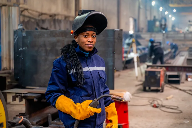 Student learning to weld at a trade school