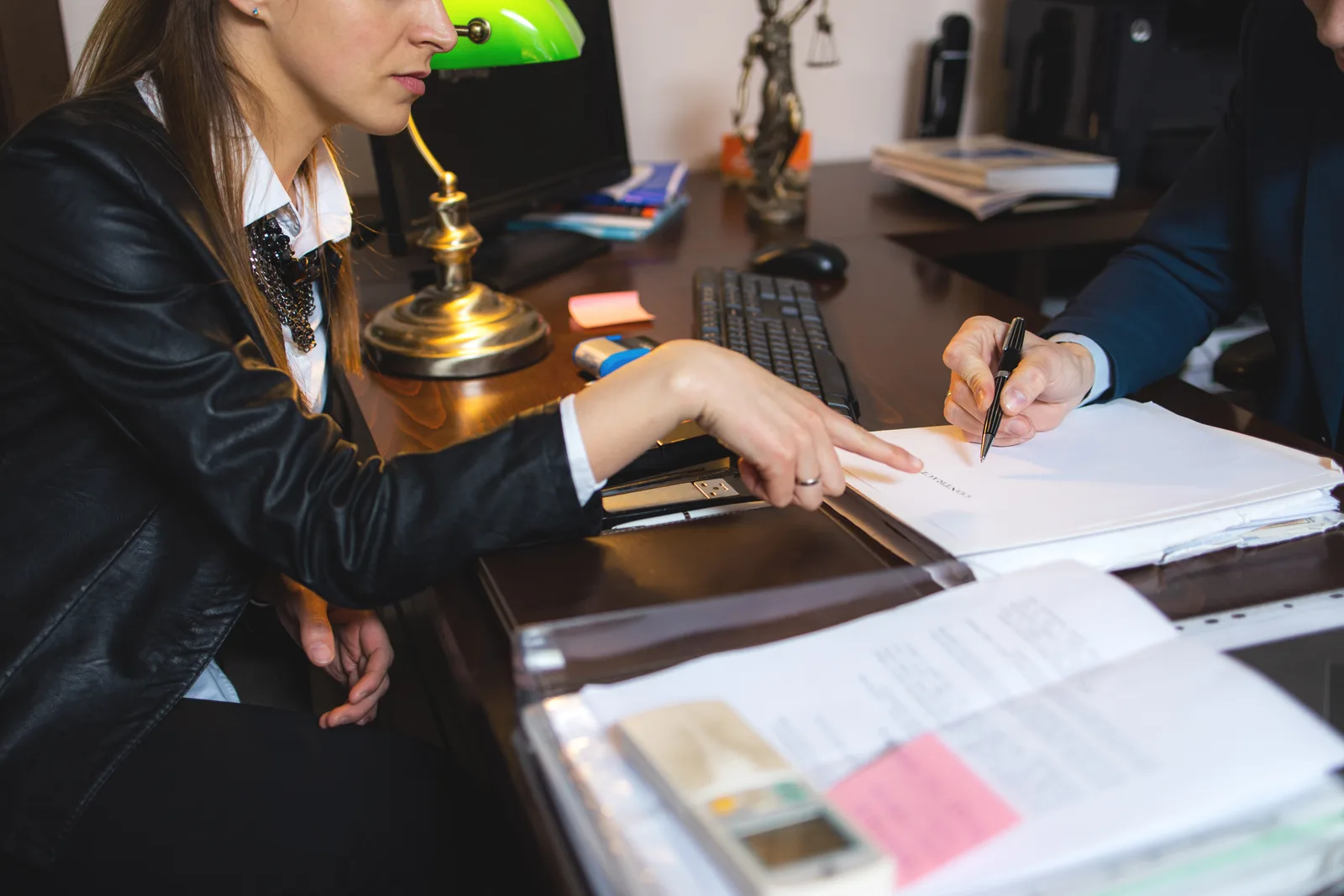 Traffic ticket defense attorney reviewing a driver's citation and court paperwork at her desk