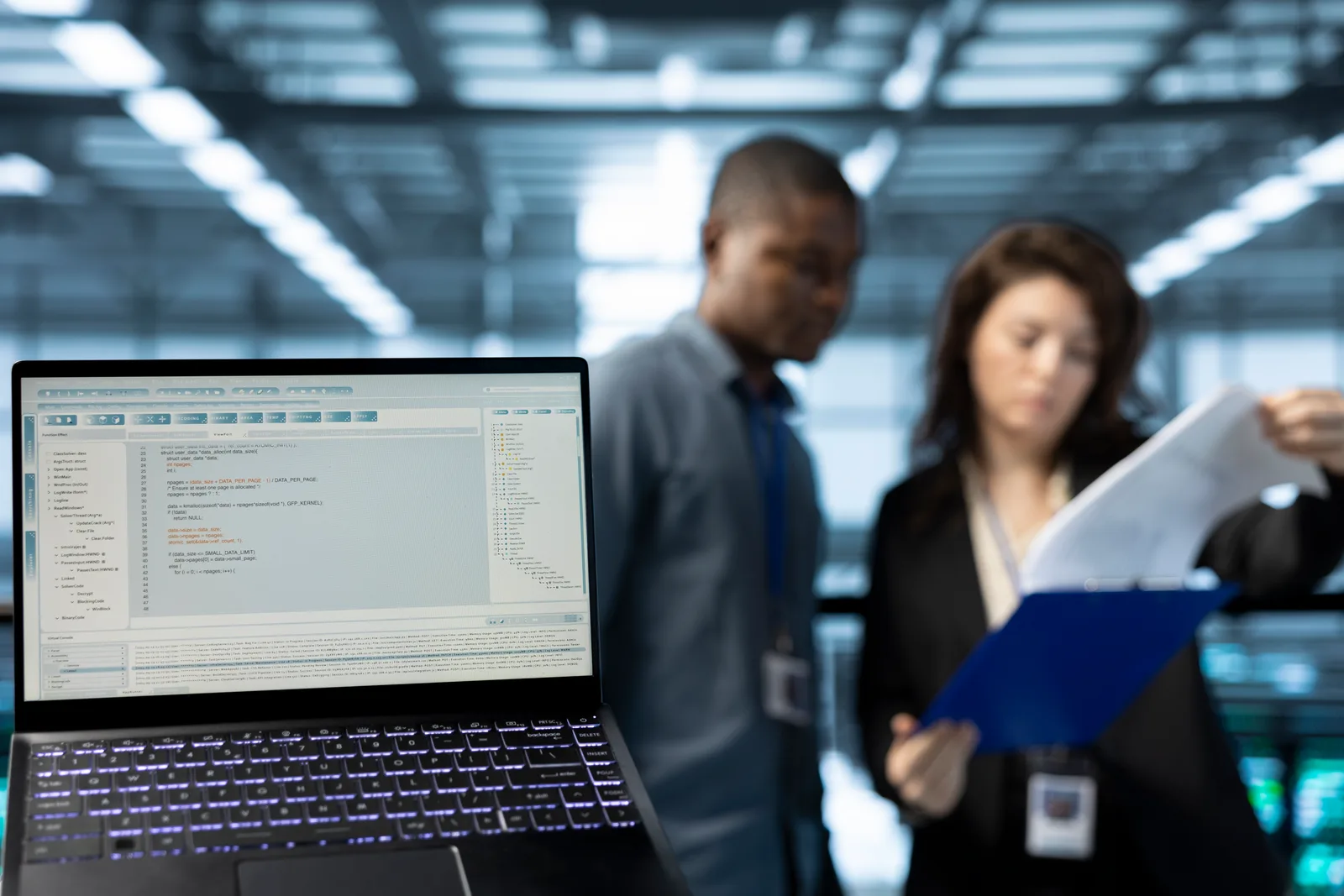 Infrastructure engineering team reviewing a live API usage and billing dashboard together at a laptop in their office