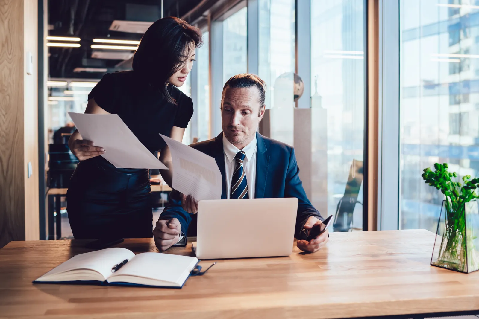 Startup lawyer reviewing a term sheet with a founder at a laptop in a modern office