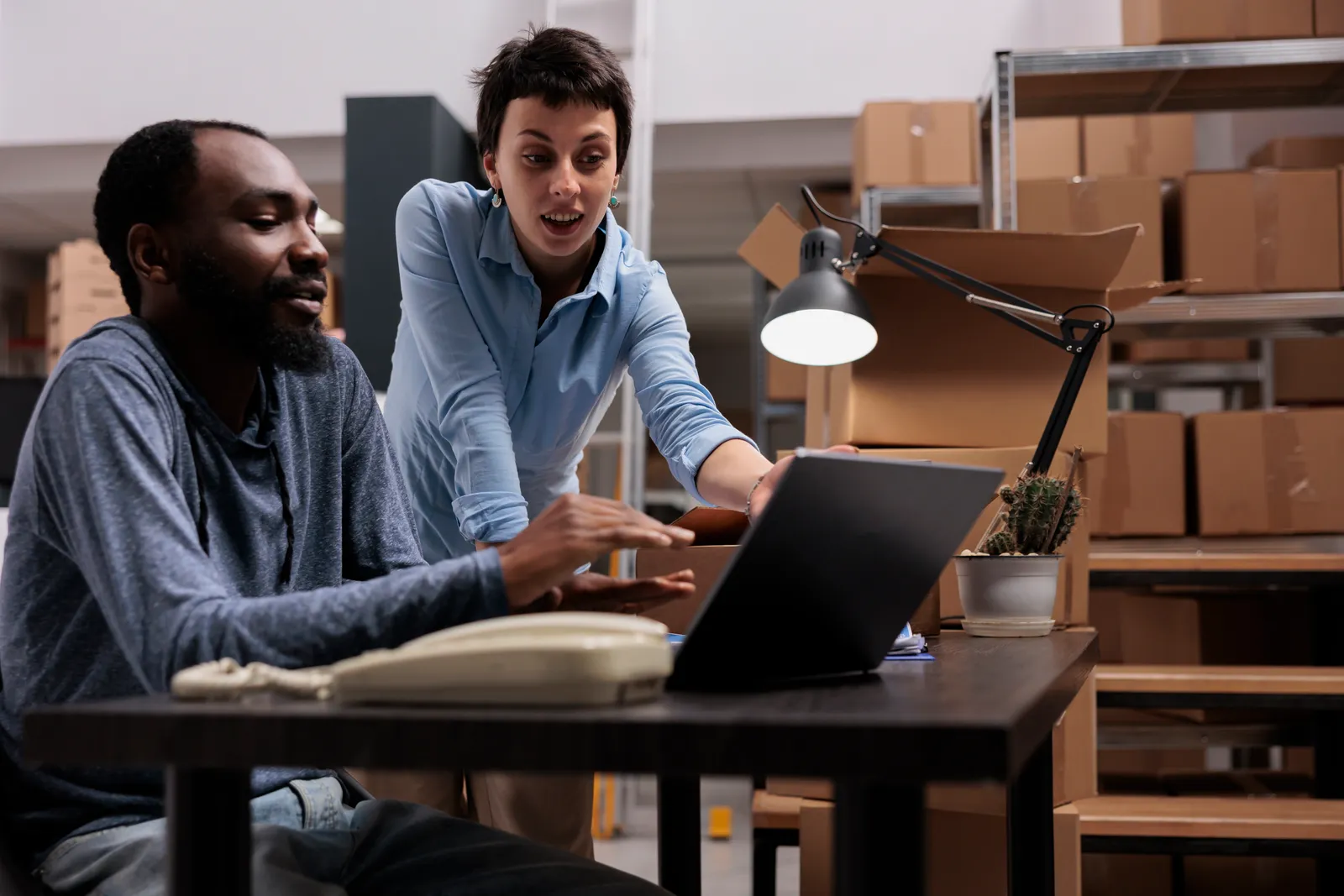 B2B marketplace team reviewing supplier and buyer order data together on a laptop in their office