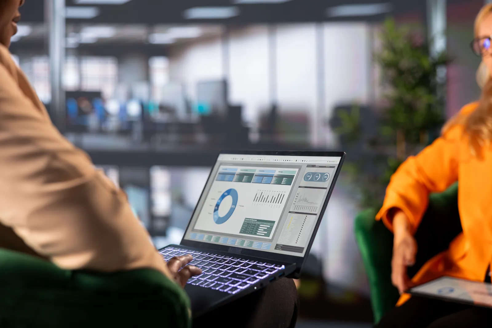 Operations team reviewing a team capacity and workload dashboard together at a laptop in their office