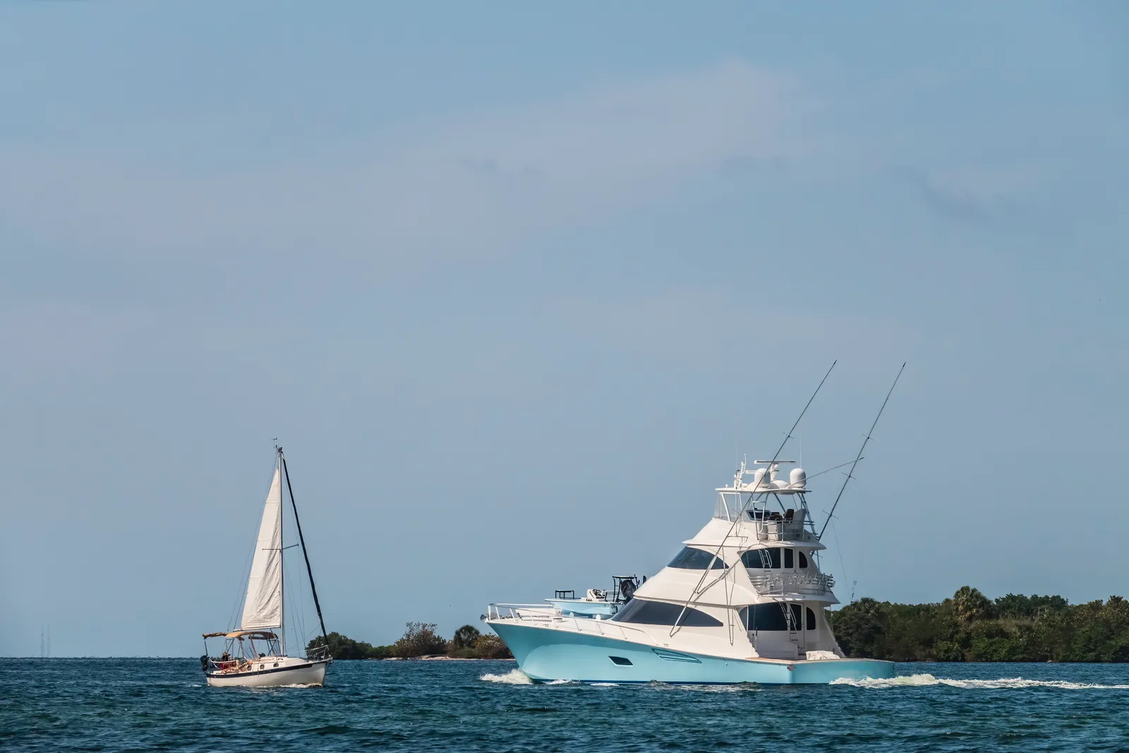 Luxury motor yacht cruising open water near the coastline