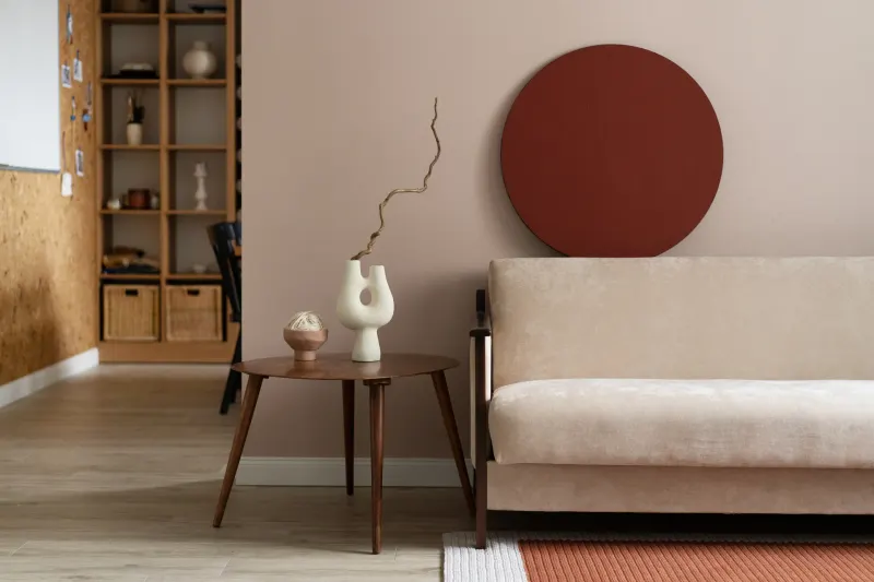 Second angle of the suite 808 living room showing the rust-red circle artwork and open shelving