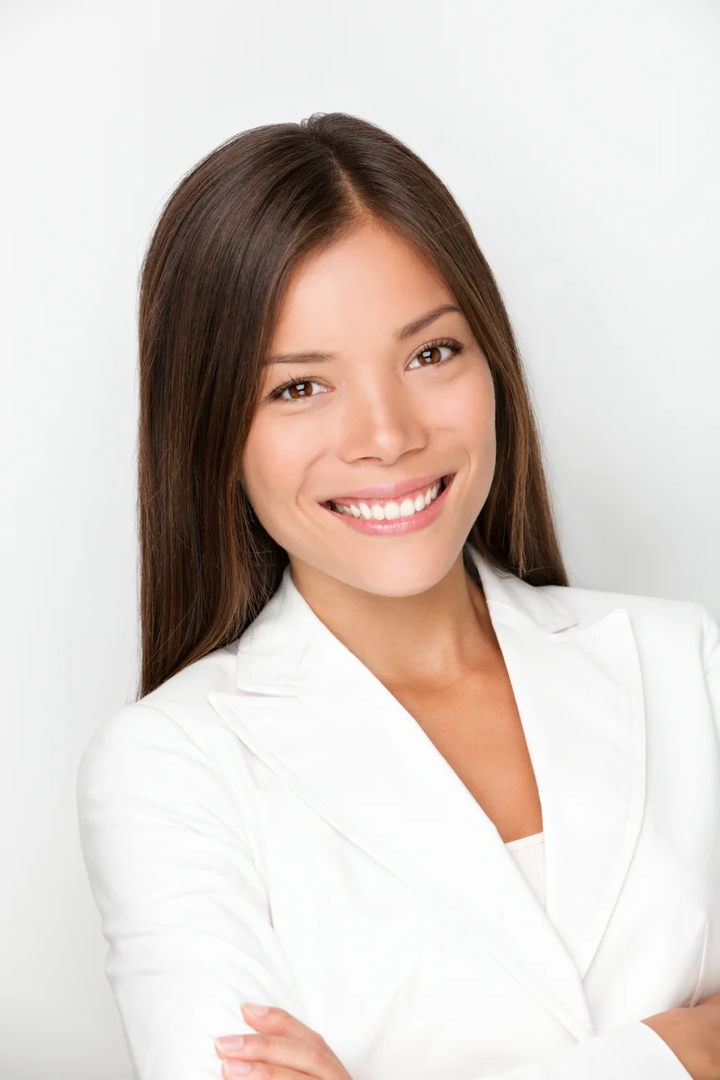 Celine Vo, Cardinal's Uptown condo specialist, smiling in a white blazer