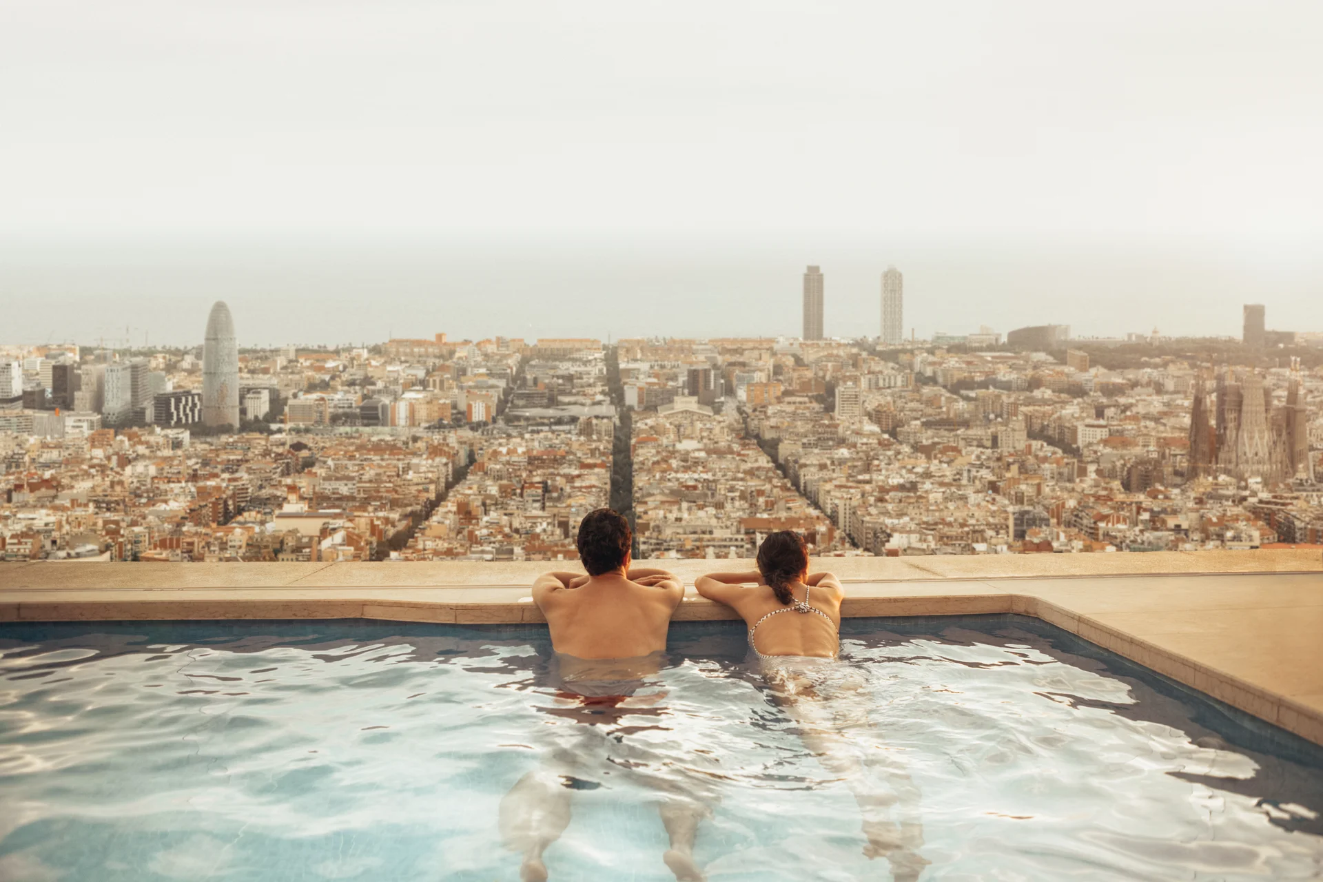 The view from a Meridian Quay rooftop pool at dusk — the whole grid of Alderport running to the sea