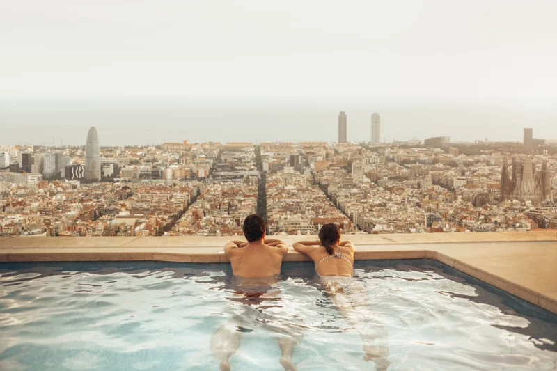 The view from a Meridian Quay rooftop pool at dusk — the whole grid of Alderport running to the sea