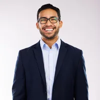 Arjun Mehta, senior solutions engineer at Vault Security, in a navy suit and glasses