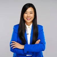 Grace Yoon, principal solutions engineer at Vault Security, smiling in a bright blue blazer